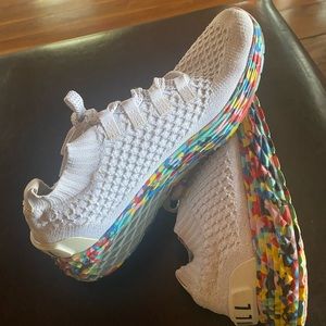 NOBULL runners in white wild with multi color bottoms.